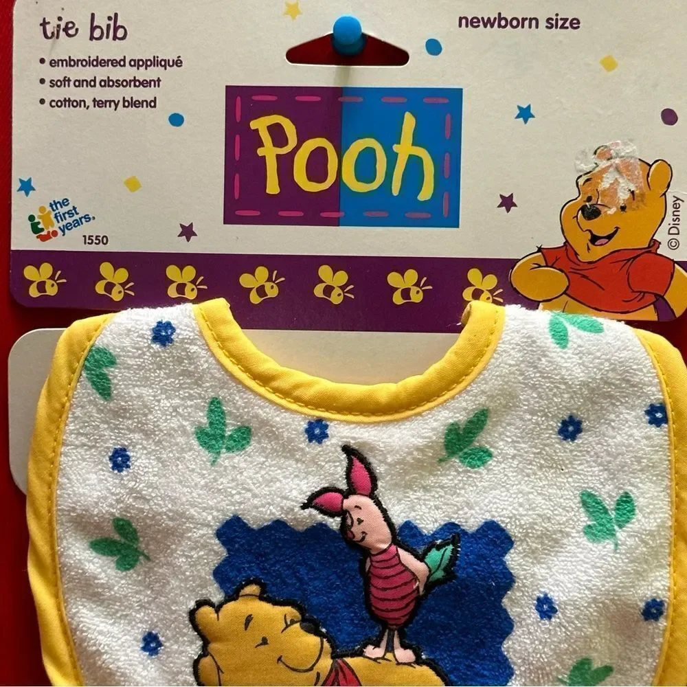 The first years Pooh Tie Bib Newborn
